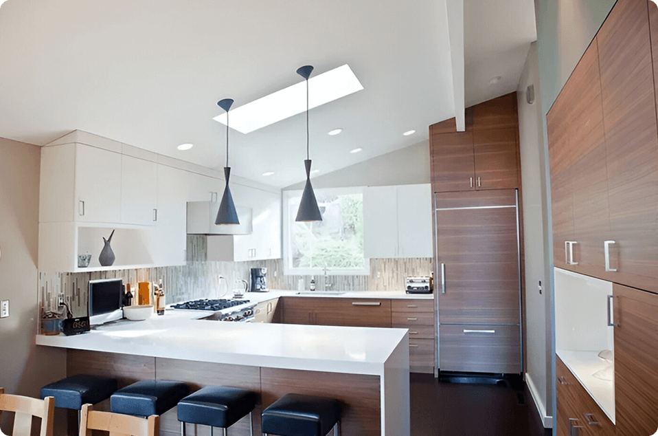 A kitchen with a lot of counter space and lighting